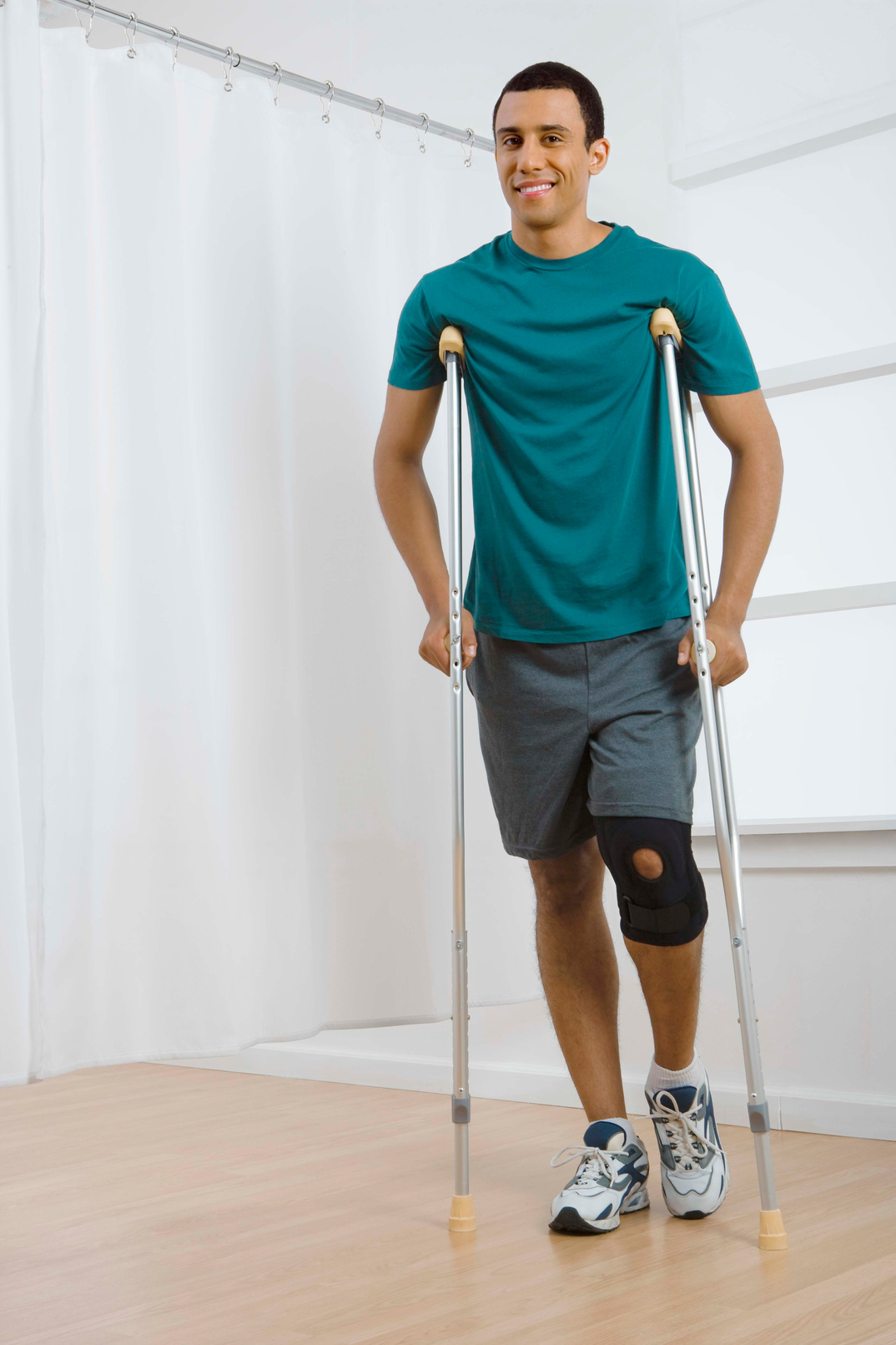 Man with knee brace and crutches